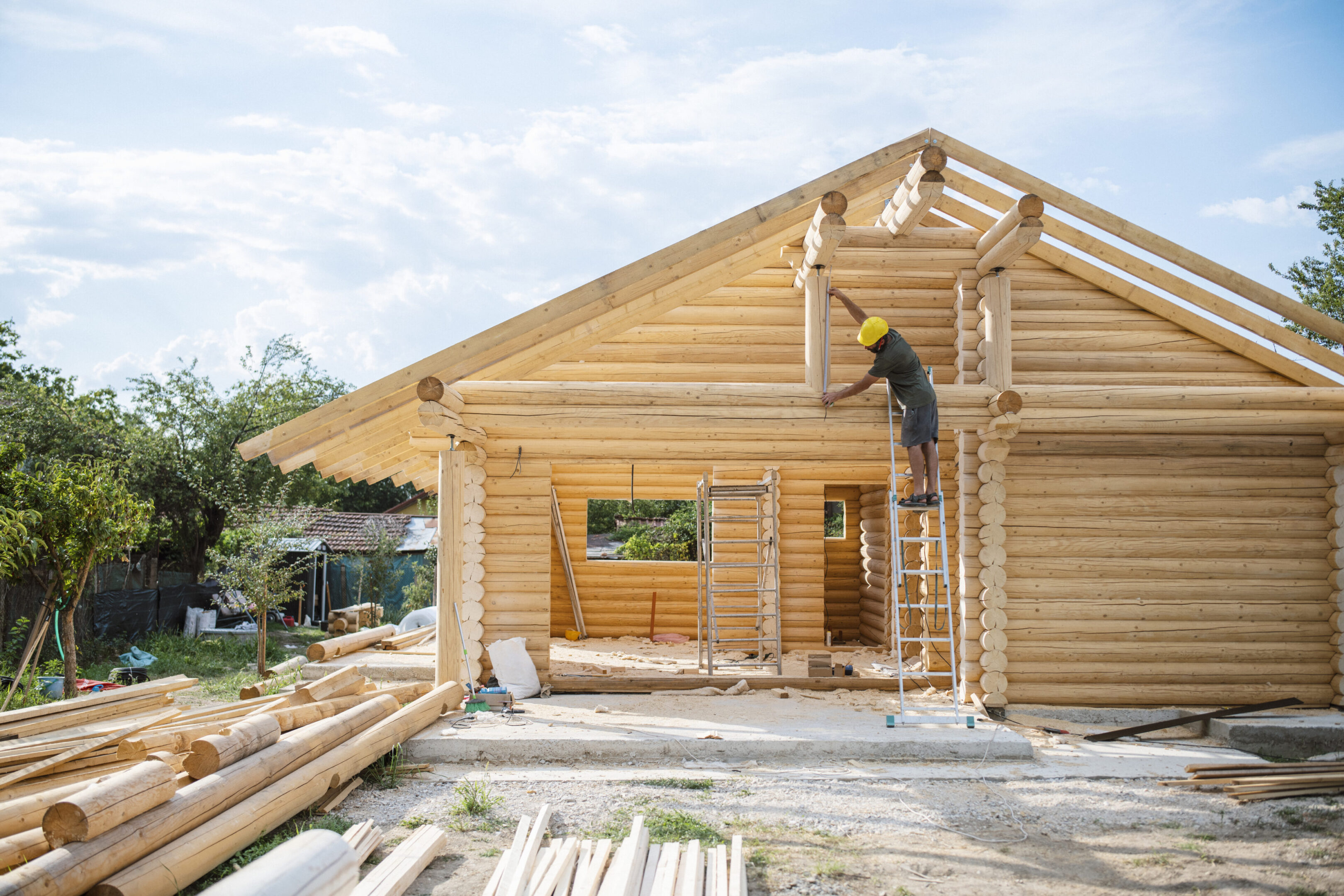 Hard working professional builder working on log cabin.