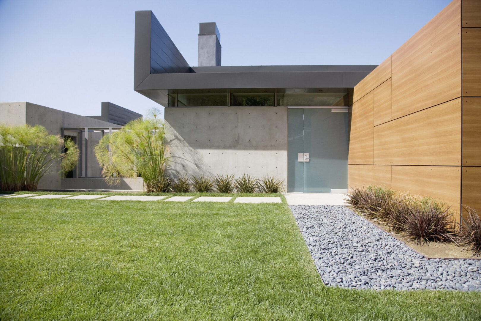 Minimalist building facade with green lawn