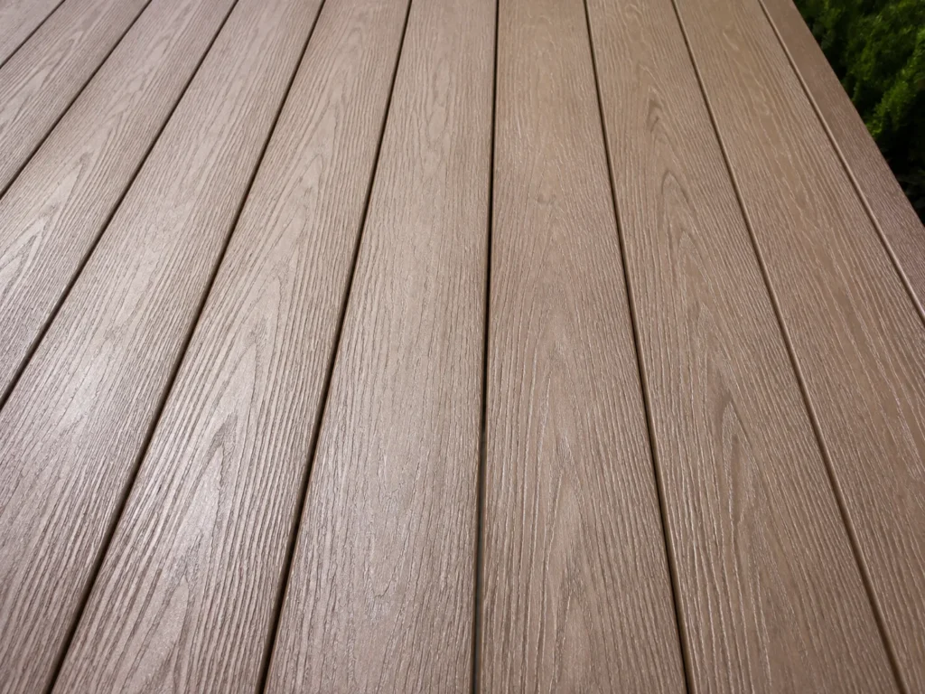Close-up view of composite decking boards showing natural wood texture and clean installation details
